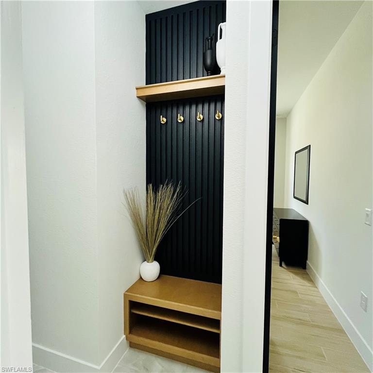 Mudroom with baseboards and light wood-style flooring