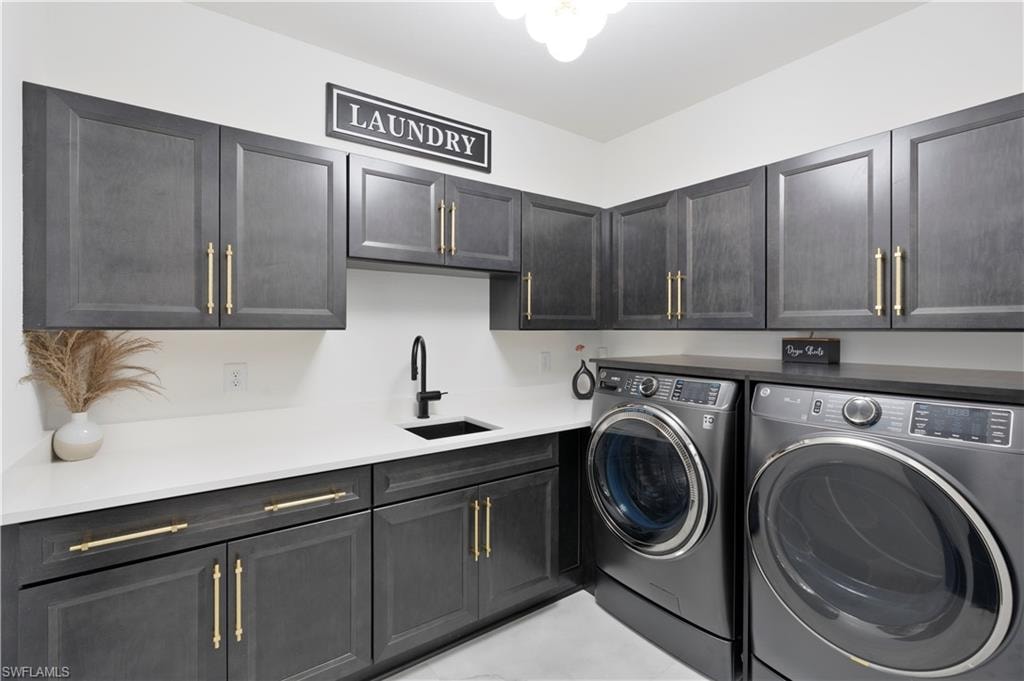Laundry area featuring washing machine and clothes dryer and cabinet space