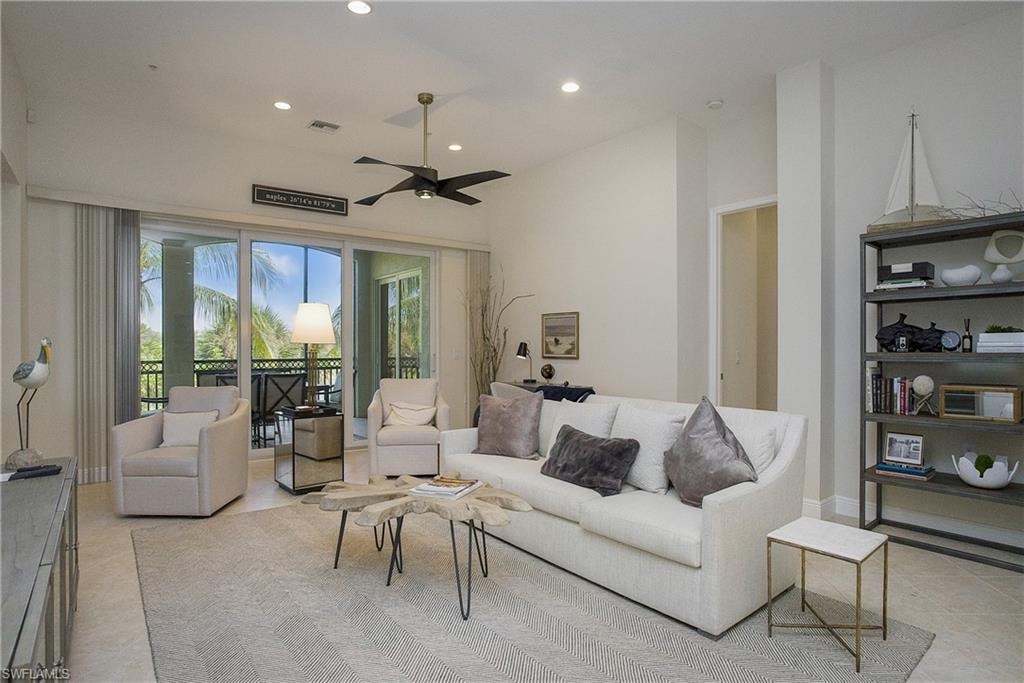 Tiled living room featuring ceiling fan