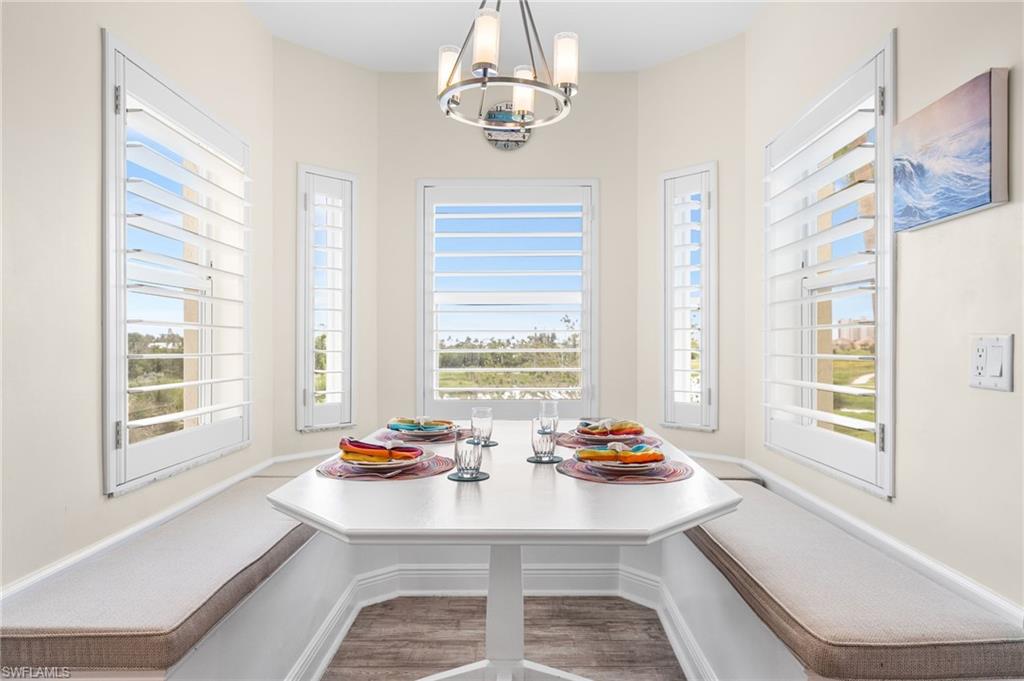 Dining room with breakfast area, a chandelier, and light wood-style flooring