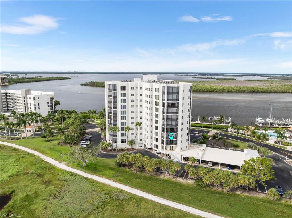 Drone / aerial view of apartment complex and a nearby body of water