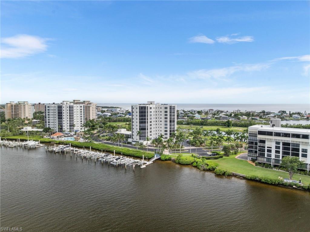 Drone / aerial view of apartment complex / building and a large body of water