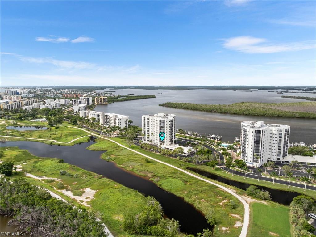 View of urban area with apartment complex / building and a nearby body of water
