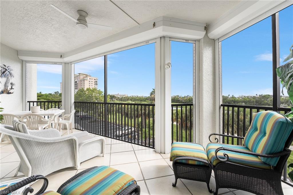Sunroom featuring a textured ceiling and tile patterned flooring