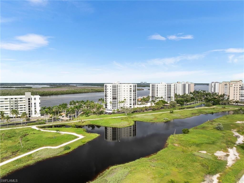 Drone / aerial view of apartment complex / building and a large body of water