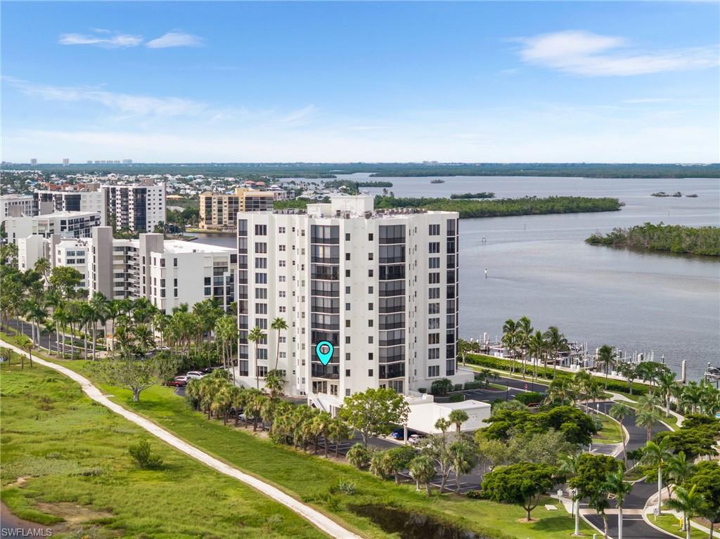Aerial view of apartment complex / building and a nearby body of water