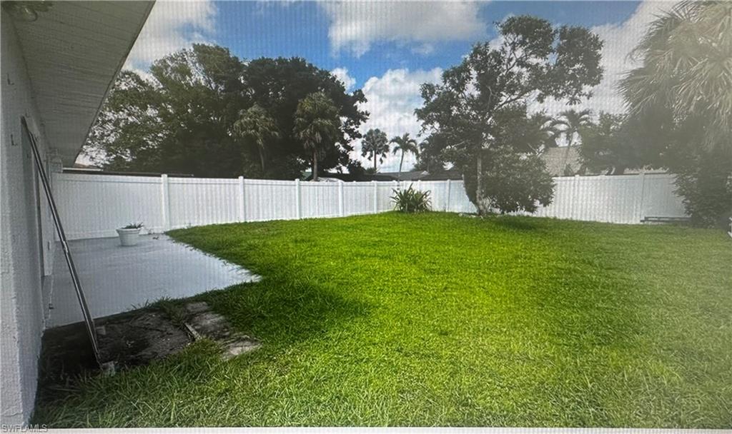 Fenced backyard featuring a patio