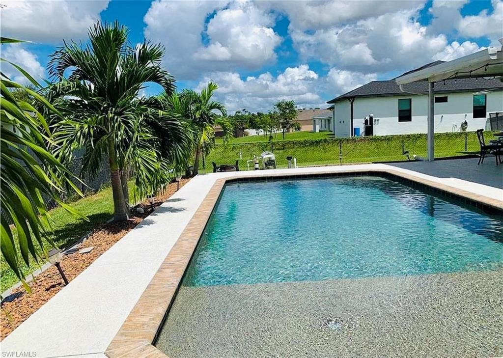 Swimming pool featuring a patio area and a yard