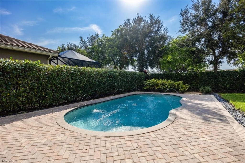 View of pool featuring pool water feature and a patio area
