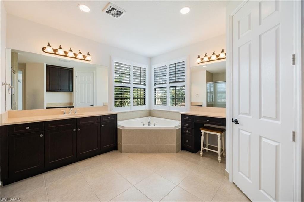 Bathroom with vanity, tile patterned floors, and separate shower and tub