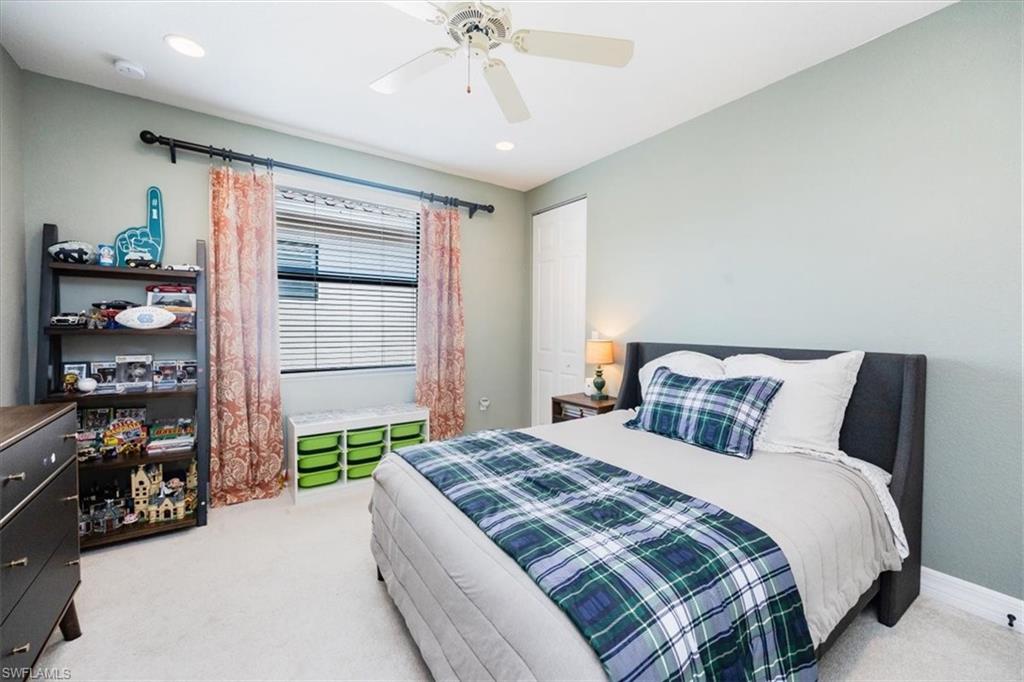 Bedroom featuring light colored carpet and ceiling fan