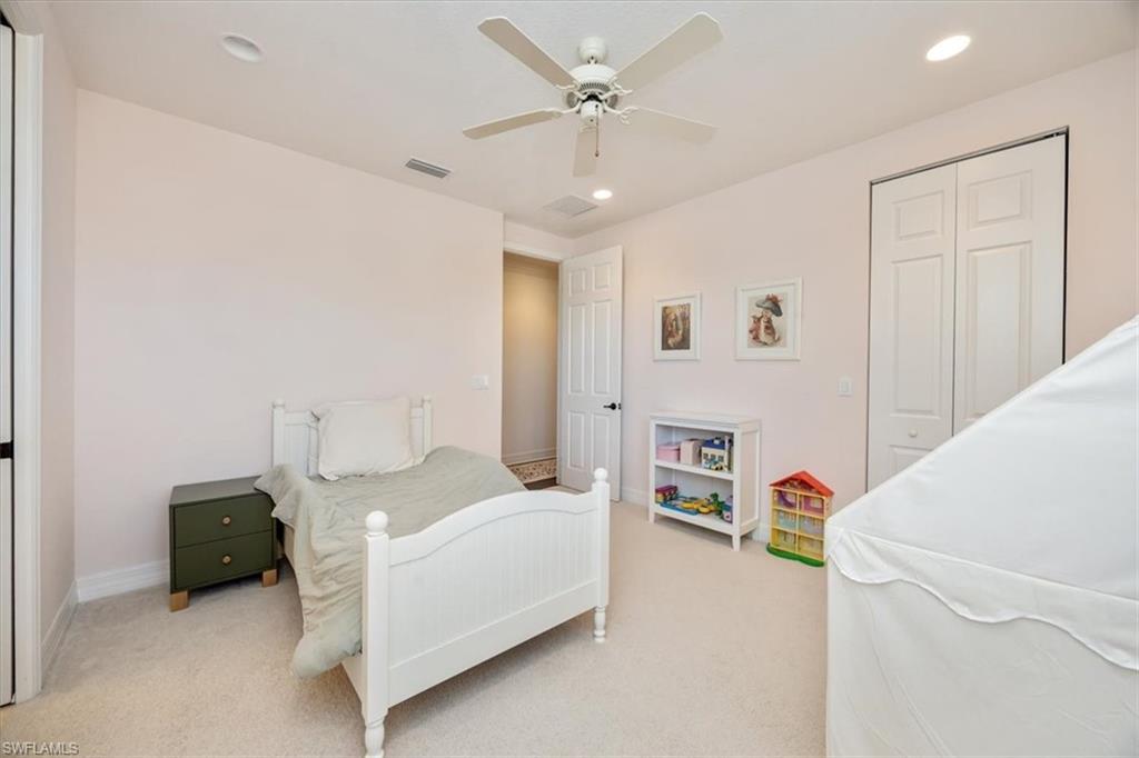 Carpeted bedroom with a closet, ceiling fan, and recessed lighting