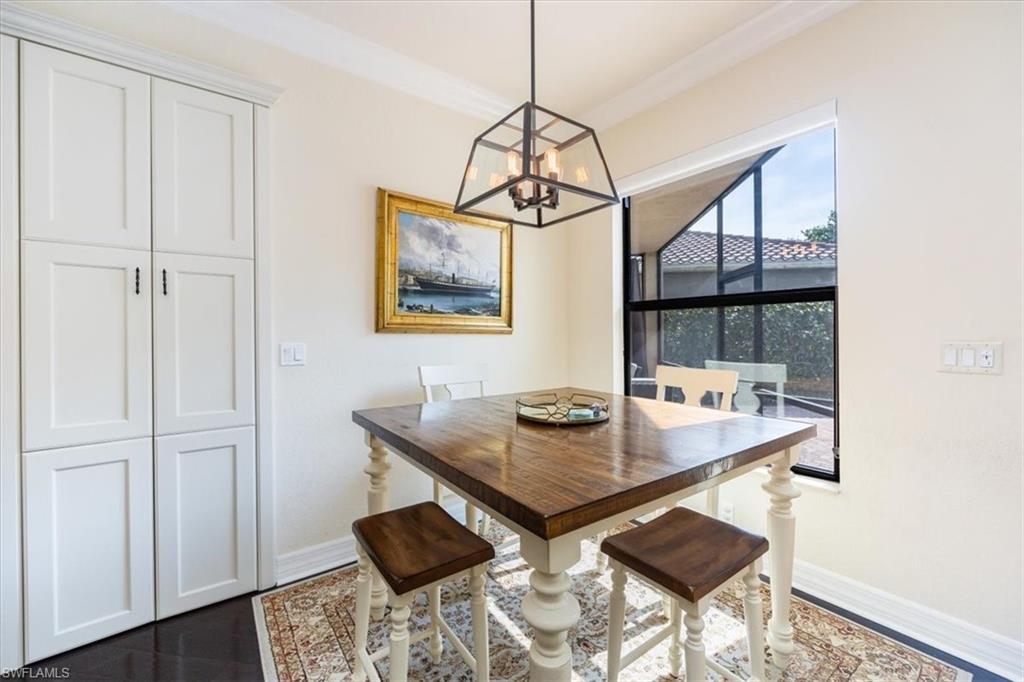 Dining space with ornamental molding and a chandelier