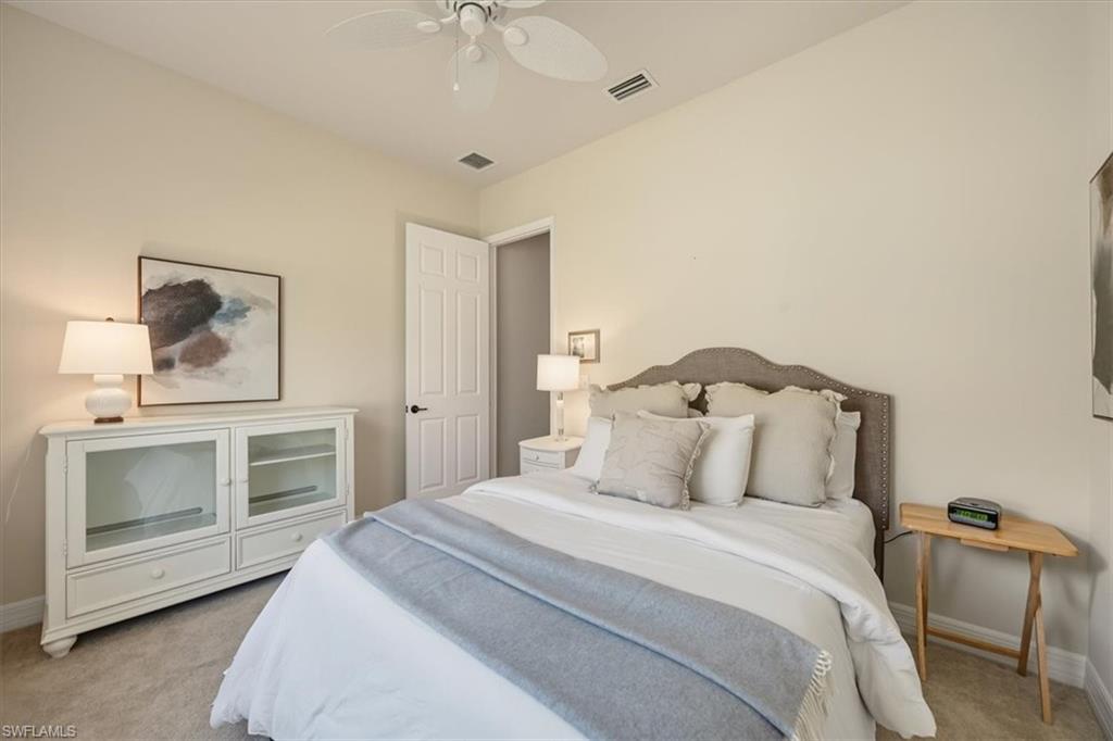 Bedroom with light carpet and a ceiling fan