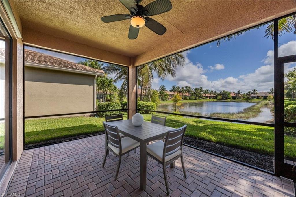 Sunroom / solarium with a patio, a water view, a ceiling fan, and outdoor dining area