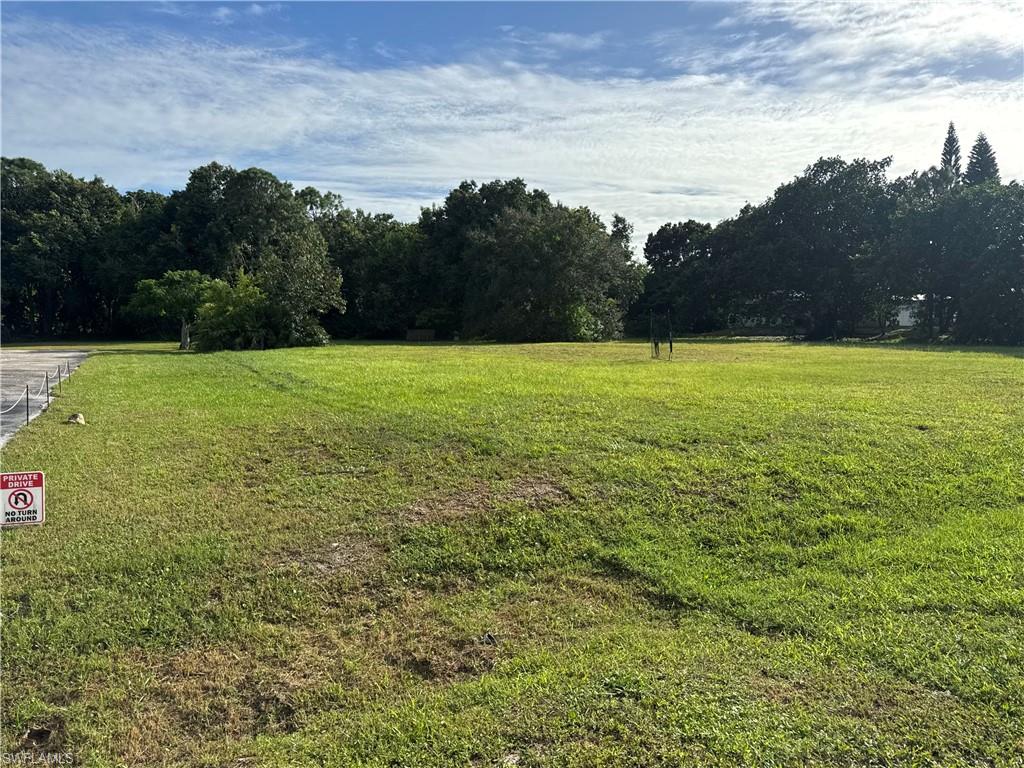View of green lawn with a rural view
