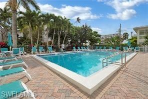 Community pool with a patio