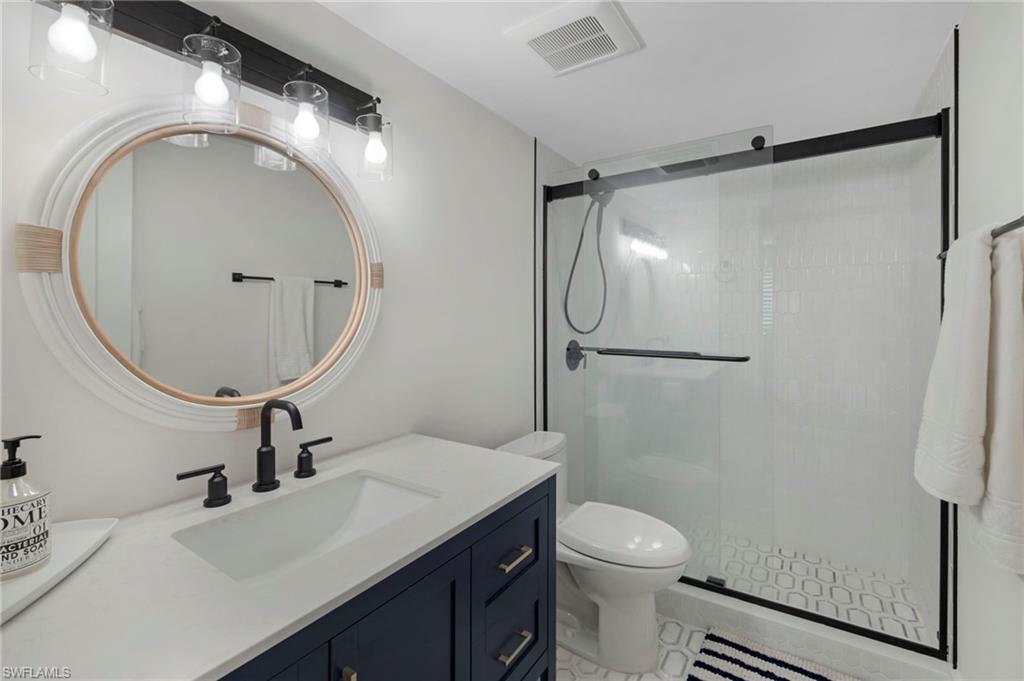 Full bathroom with a stall shower and vanity