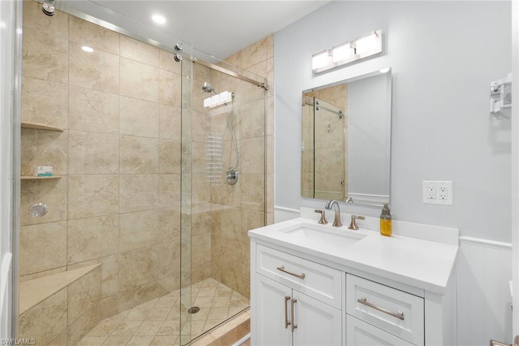 Bathroom featuring a stall shower and vanity