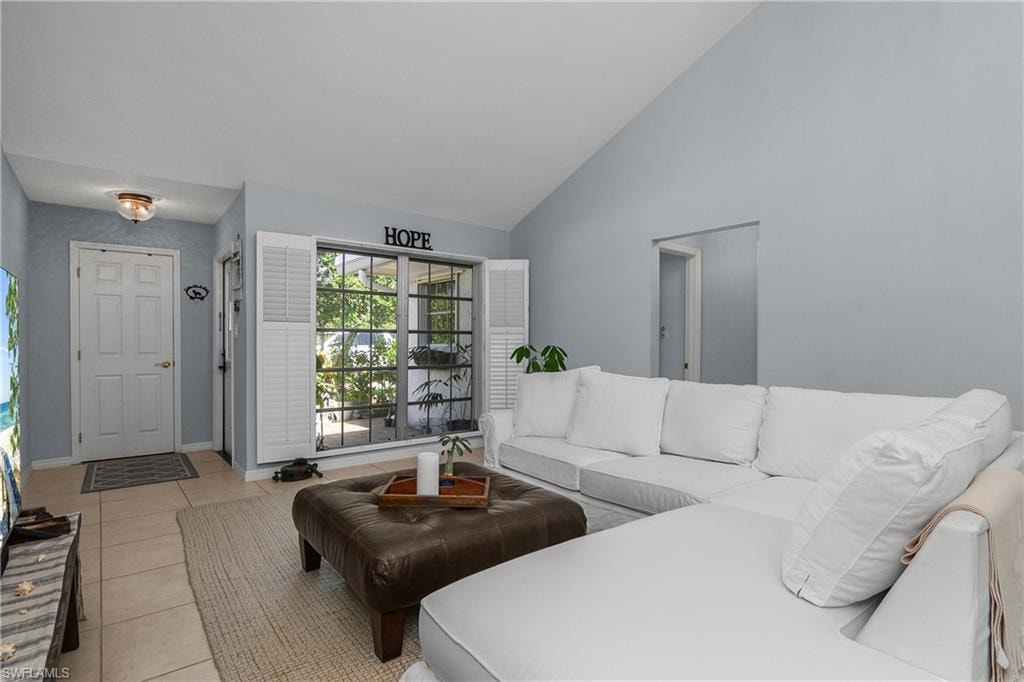 Tiled living area with high vaulted ceiling