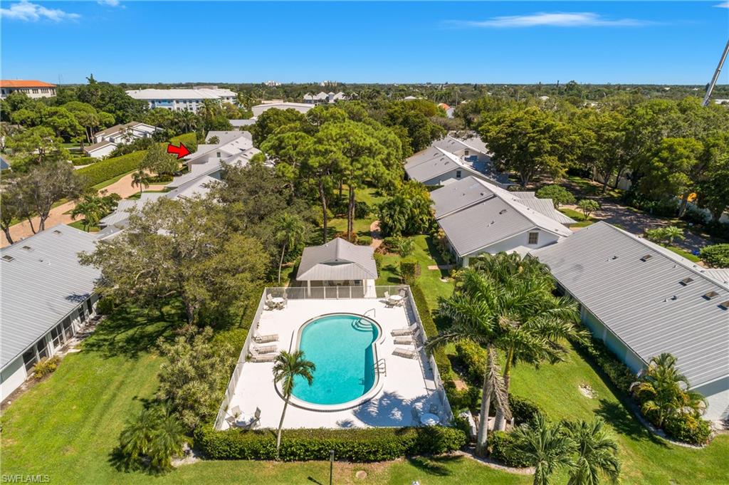 Aerial view of residential area featuring a pool