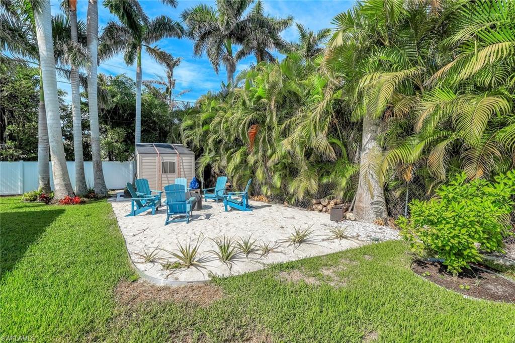 Fenced backyard featuring a patio and a storage unit