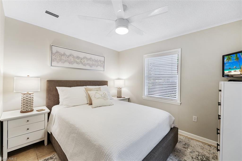 Bedroom featuring a textured ceiling and a ceiling fan
