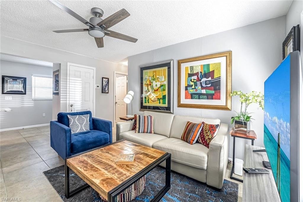 Living area featuring a textured ceiling and a ceiling fan