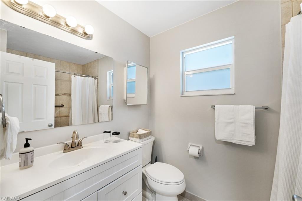 Full bath with vanity and a shower with curtain