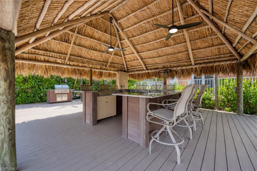 Deck featuring an outdoor kitchen and a ceiling fan