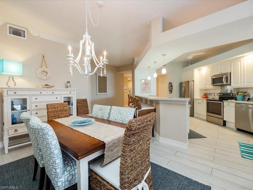 Dining area with light wood-style flooring and a chandelier