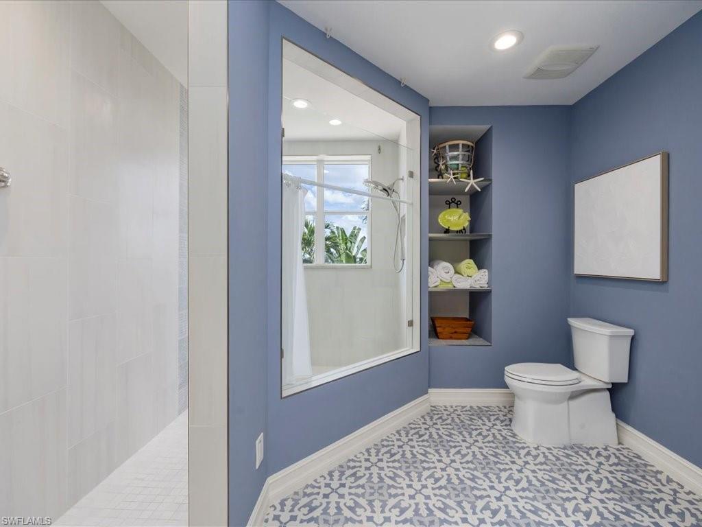 Bathroom with walk in shower and recessed lighting