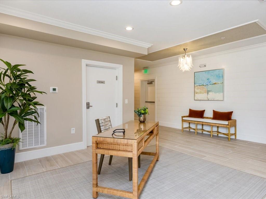 Office area with wood finish floors, ornamental molding, recessed lighting, and a chandelier