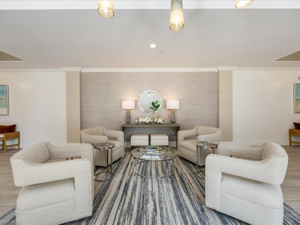 Living room featuring wood finished floors, crown molding, and recessed lighting