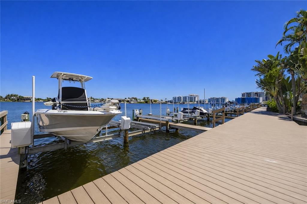 Dock featuring boat lift and a water view