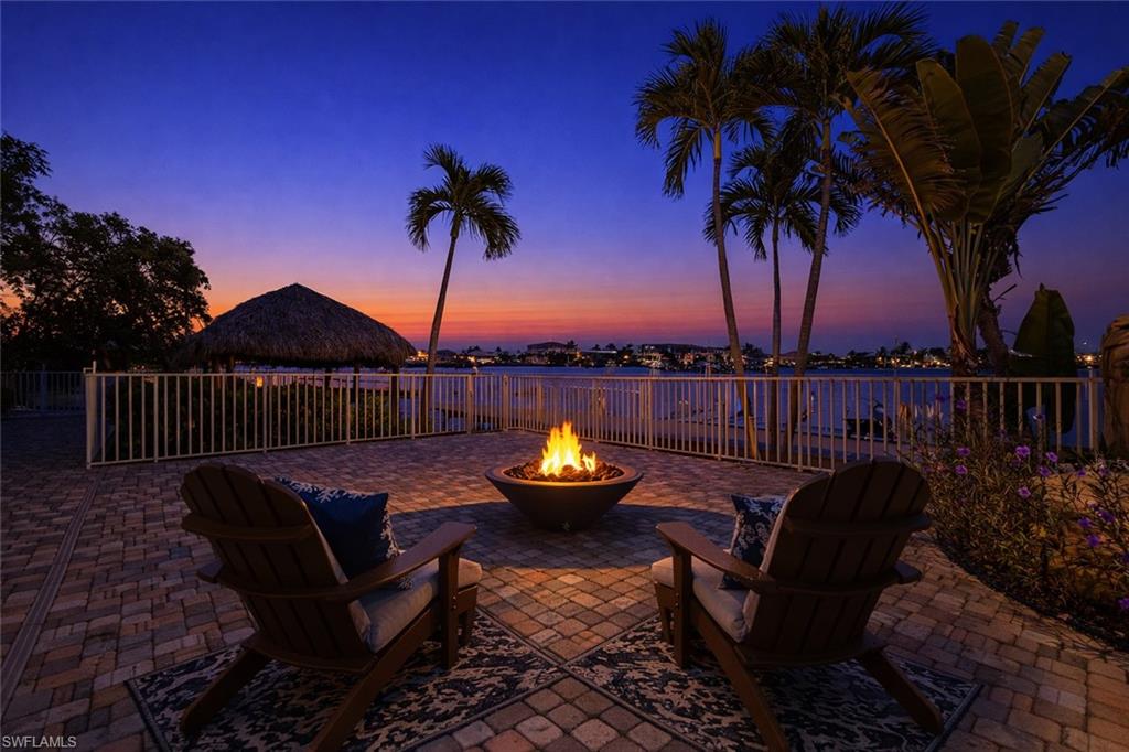 Patio terrace at dusk featuring a fire pit and a patio