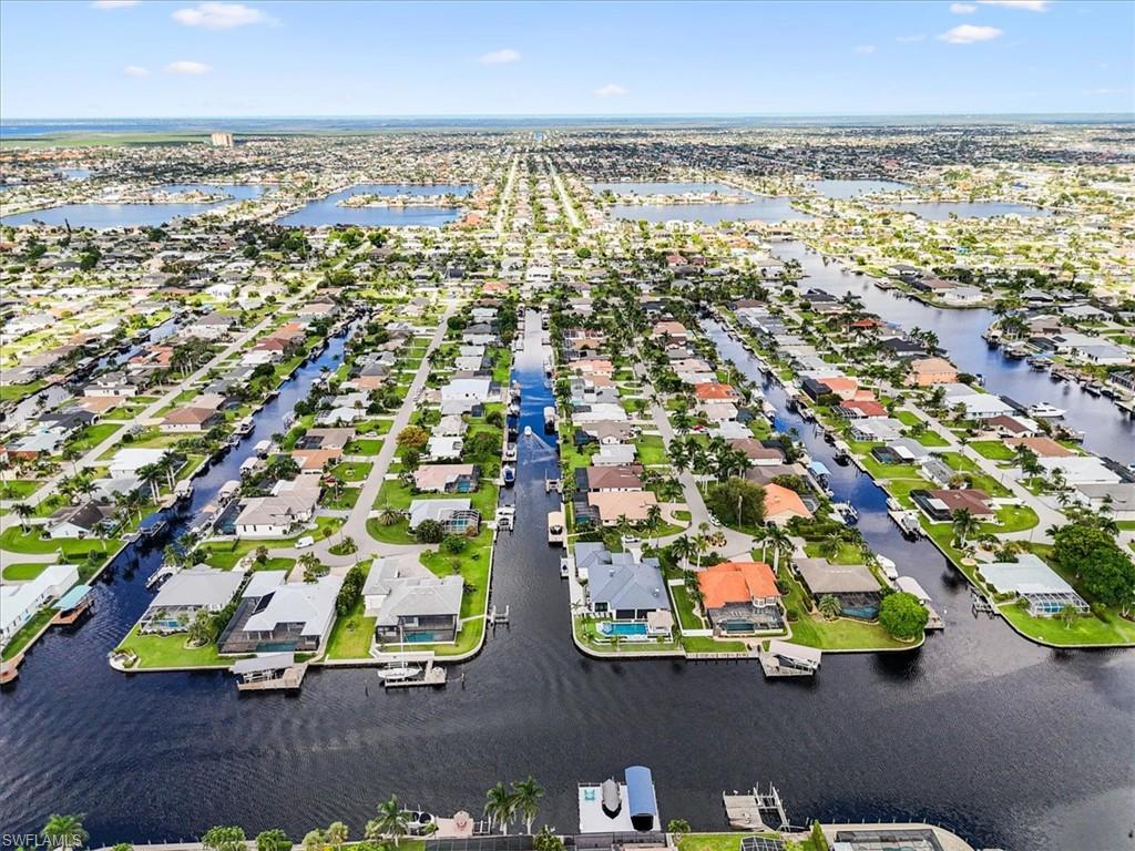 Aerial view of residential area featuring a nearby body of water