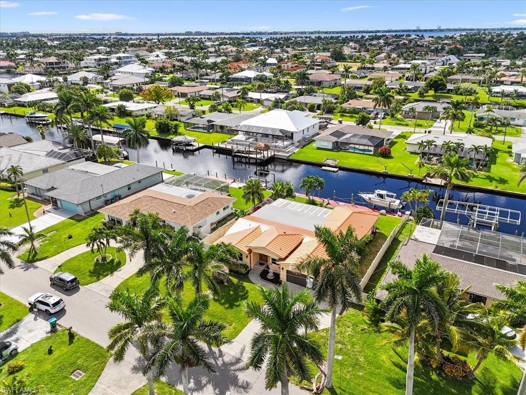 Aerial view of residential area featuring a large body of water