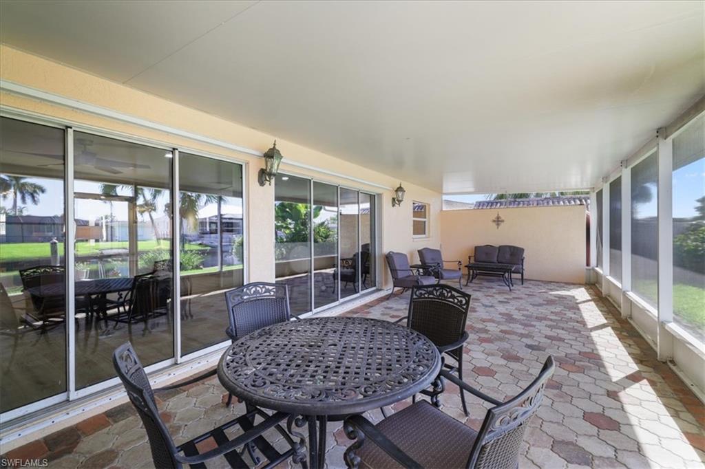 Sunroom / solarium featuring healthy amount of natural light, outdoor dining area, and an outdoor hangout area