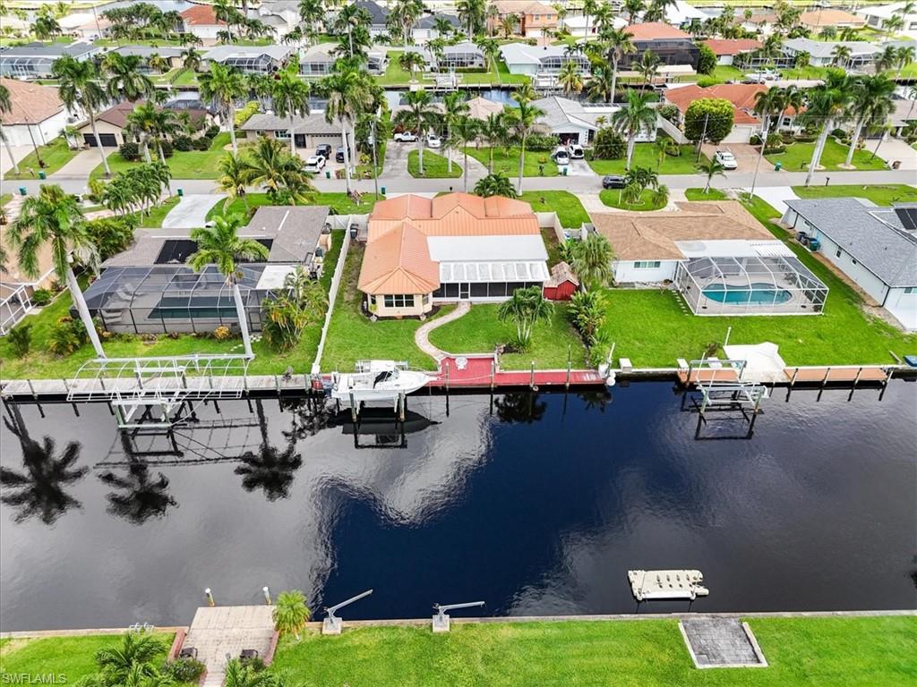 Aerial view of residential area featuring a nearby body of water