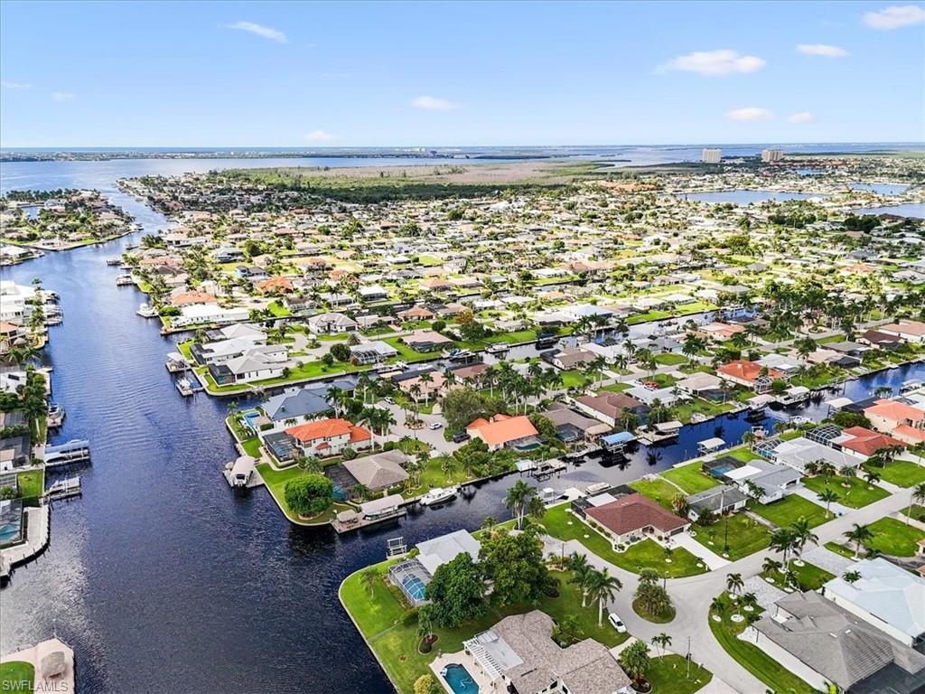 Aerial perspective of suburban area with a nearby body of water