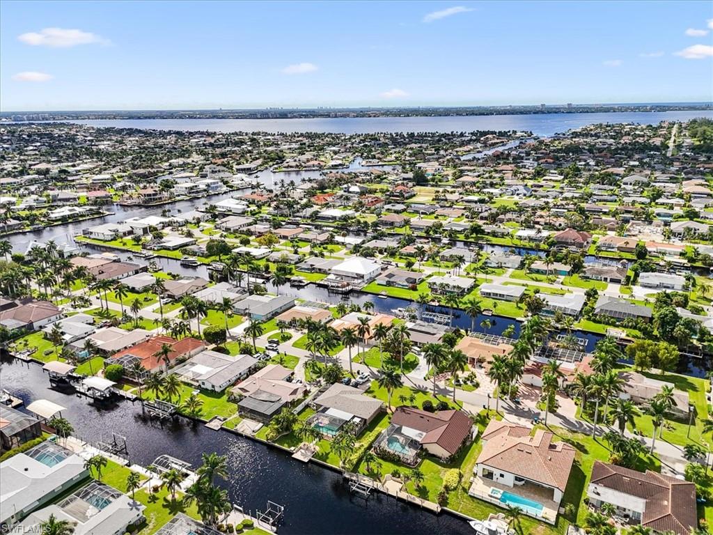 Aerial view of residential area featuring a nearby body of water