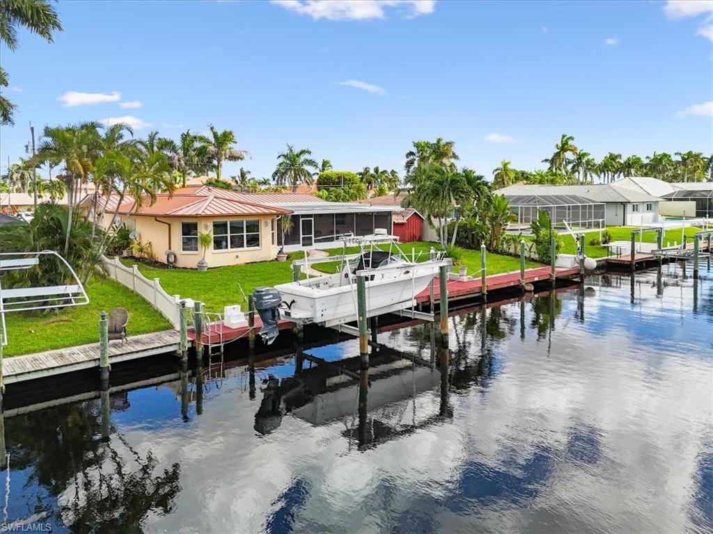 Dock with boat lift and a water view