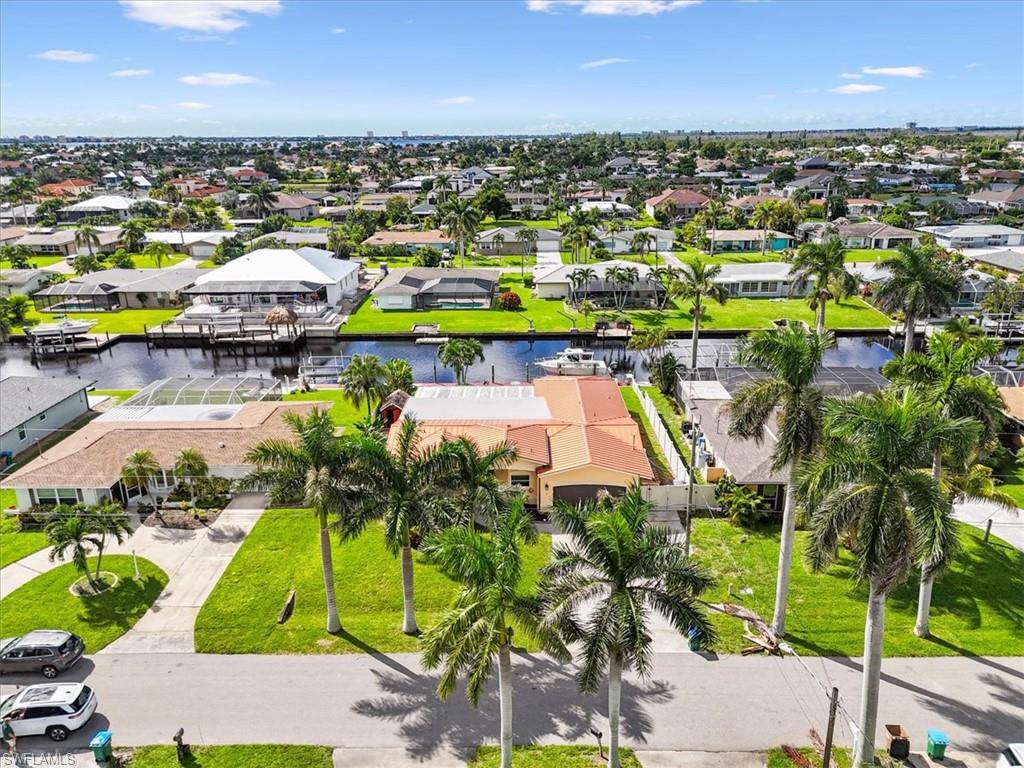 Aerial perspective of suburban area featuring a large body of water