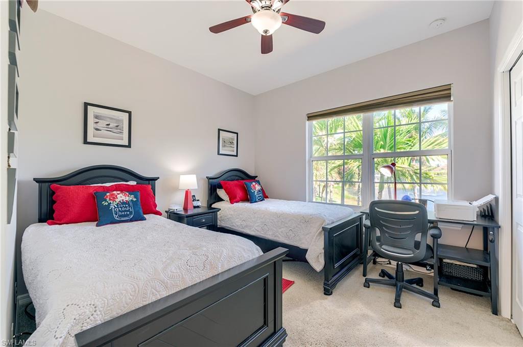 Bedroom featuring light colored carpet and ceiling fan
