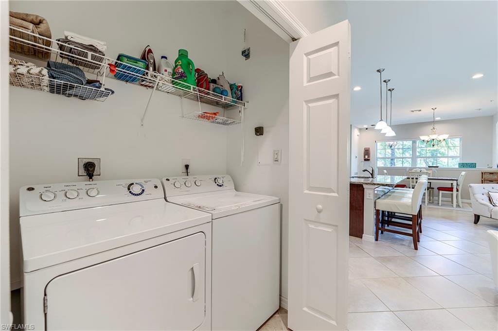 Laundry room with light tile patterned floors, separate washer and dryer, and recessed lighting