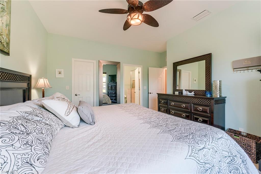 Bedroom featuring a ceiling fan and connected bathroom