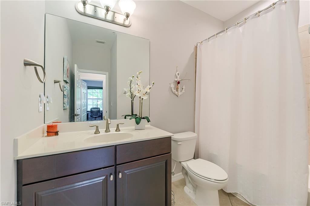Full bath with vanity and light tile patterned floors