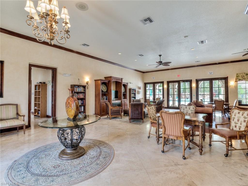 Dining room featuring ornamental molding, ceiling fan, and a chandelier