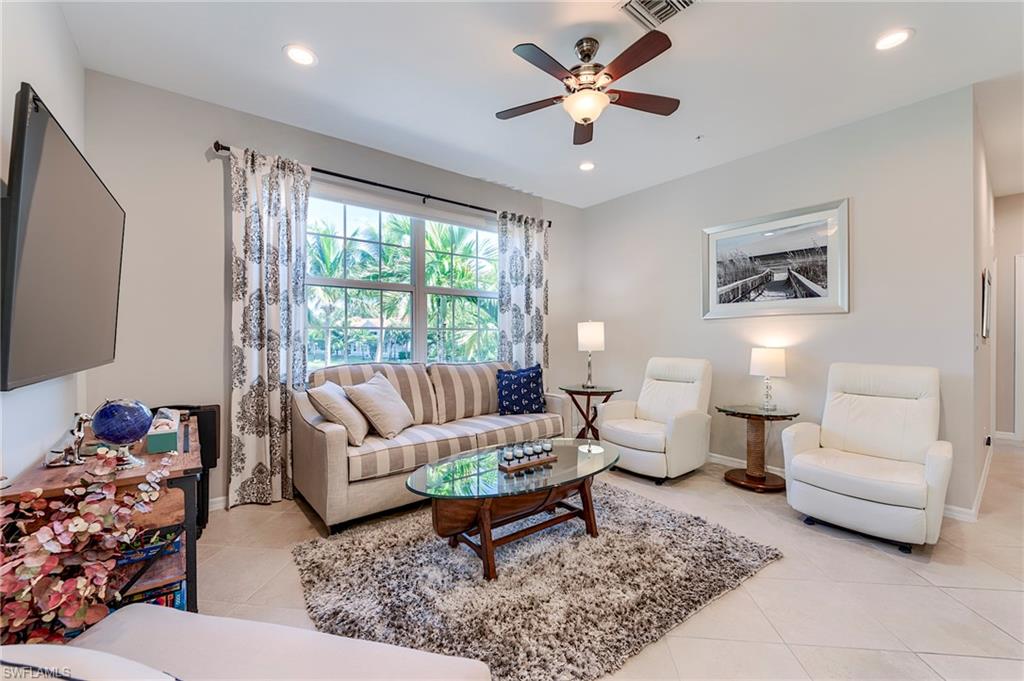 Living room featuring recessed lighting, light tile patterned flooring, and ceiling fan